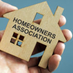 Homeowners Association HOA written on a model of home.